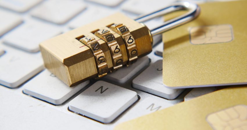 a golden padlock sitting on top of a keyboard