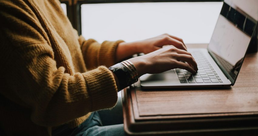 person sitting front of laptop