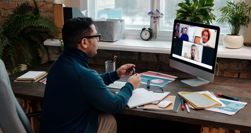 teacher-video-calling-with-his-students-using-a-computer